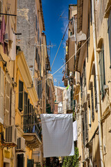 Fototapeta na wymiar Washed laundry is dried on clothesline in Corfu, Greece.