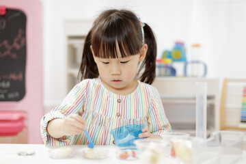 young  girl  play science experiments for homeschooling