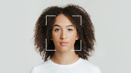Biometric facial recognition of calm young african american female, isolate on gray background - obrazy, fototapety, plakaty