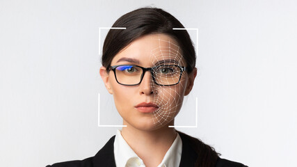 Serious millennial caucasian business woman in glasses and smart technology for face recognition