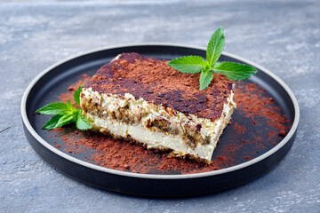 Modern Style traditionelles italienisches Tiramisu serviert als close-up auf einem Nordic Design Teller 