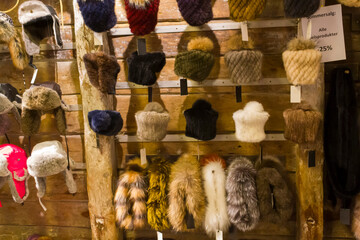 Winter caps and scarves of fur for sale indoors