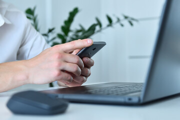 Trader man sitting in office and using smart phone.