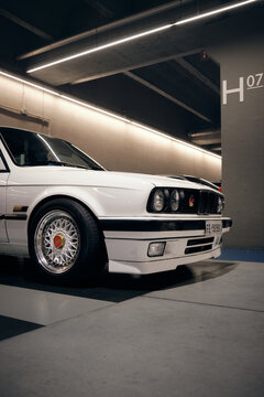 Vintage BMW e30 front quarter sportcar in a underground parking in city TURIN, ITALY - NOVEMBER 12 2019