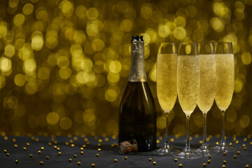 Champagne glasses on gold background, copy space for text.