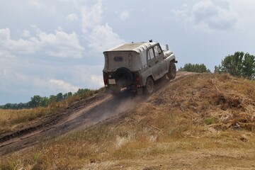 all-terrain vehicle driving up a steep hill 