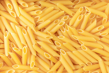 Uncooked Raw Organic Penne Pasta texture background. Pasta gourmet and pasta healthy eating concept