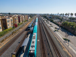 Obraz premium Aerial Drone View of a Coaster Train Parked at the Oceanside (CA) Transit Center: Transportation, Technology, Infrastructure