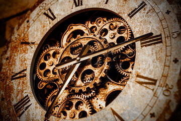 Fototapeta na wymiar A close-up of the clockwork. Iron gears and arrows.