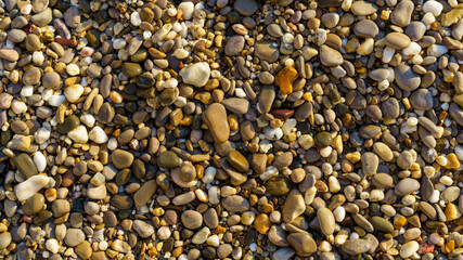 Natural textured background of multicolored pebbles