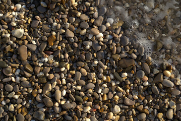 Natural textured background of multicolored pebbles