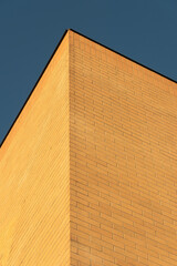 Tan Brick Wall Corner to Roof and Blue Sky
