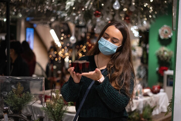Woman examining Christmas decoration in mall