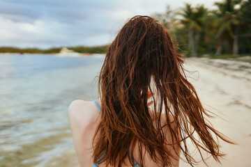 woman in blue swimsuit on the beach island lifestyle