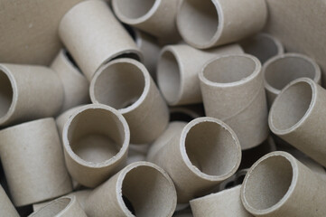 Empty spools in bulk in a box. Reels with a diameter of 40 mm for winding paper. Selective focus