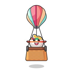 noodle bowl mascot riding a hot air balloon