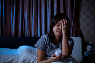 Sleeplessness Asian woman holding drug.