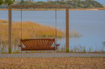 A bench swing overlooking the marsh in the town of Sunset Beach, Brunswick County, North Carolina
