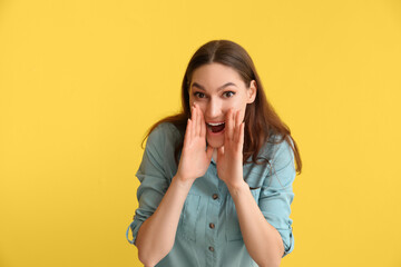 Young gossiping woman on color background