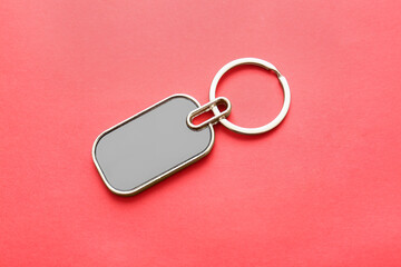 Stylish keychain on red background