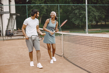 Two tennis players talking on a tennis court before the match