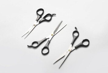 Scissors of hairdresser on white background, top view