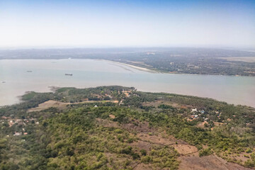 Fototapeta na wymiar Aerial river and riverbed landscape of India, with nice white clouds in the atmosphere, image shot in the sky from aeroplane. Nature stock image.