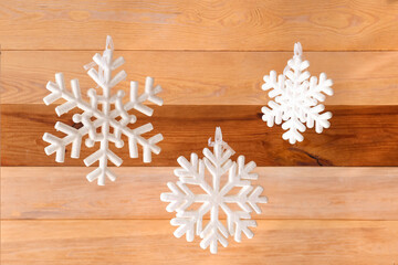 White snowflakes hanging on wooden background