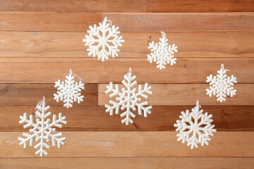 White snowflakes hanging near wooden wall