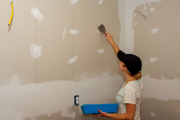 Kitchen Remodel Young Woman Filling Drywall Holes