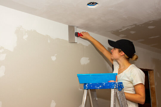 Kitchen Remodel Young Woman Taping Ceiling Joint Wearing Hat