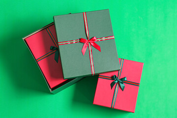 Beautiful Christmas gift boxes on green background