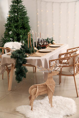Dining table with beautiful setting for Christmas celebration in festive room