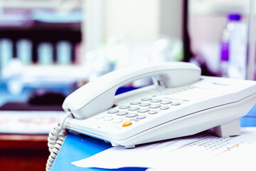 Office telephone on desk,telephone on table with blur office background..