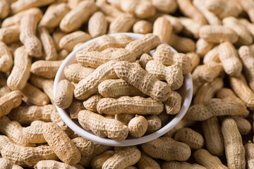 Dried peanuts in plate background