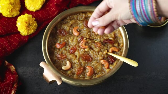 Sakkarai pongal Indian festival food woman hand serving traditional mithai sweet pongal 4K video footage dessert made on the festival day of Pongal Makar Sankranti vishu Diwali India.