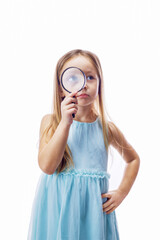 Little girl child looking through a magnifying glass, isolated on white background. Investigation, discovery and vision concept.