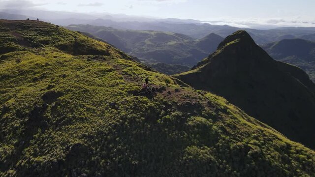 Aerial orbiting video of a group of people having breakfast on a mountain ridge in front of Pelado peak in Costa Rica. Central America during wet season captured in ultra HD. Eco tourism concepts.