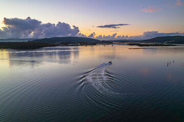 Aerial sunrise over the bay with clouds and reflections