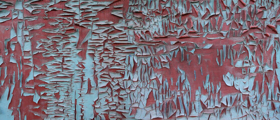 wooden wall of an old house with peeling paint