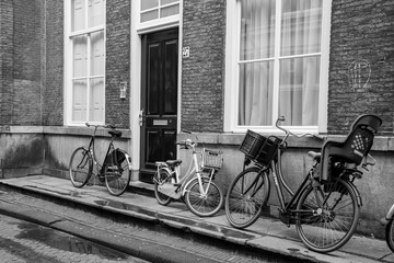 Europe, Netherlands, The Hague.Bicycles in front of brick building.