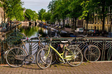 Fototapeta na wymiar Bicycles on bridge over canal, Amsterdam, Holland, Netherlands.