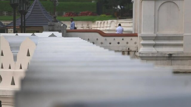 Close up view from top of the wall of the Temple of the Sacred Tooth Relic or Sri Dalada Maligawa with tourists watching and walking around in Sri Lanka, Dec. 2014