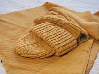 a set of warm yellow clothes. hat mittens and scarf