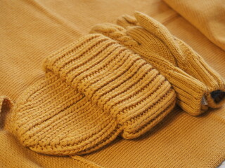 a set of warm yellow clothes. hat mittens and scarf