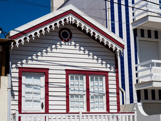 Fototapeta na wymiar Portugal, Costa Nova. Colorful houses Palheiros striped homes