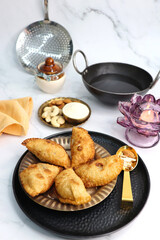 Indian Holi snack popuraly known as Gujia or Gujiya. Also called Karanji in Maharashtra, mostly eaten during Diwali. It is a deep fried sweet dish made from maida and stuffed with khoya or rava. copy.