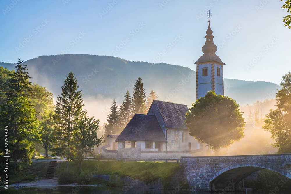 Sticker europe, lake bohinj. st. john the baptist church on foggy sunrise.