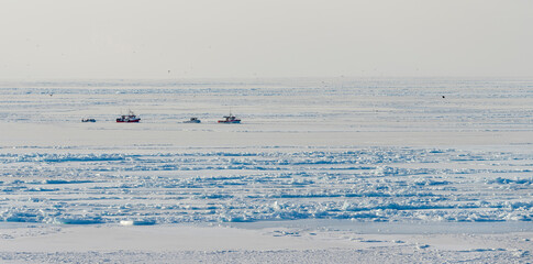 Ships in the sea ice of the frozen Disko Bay during winter, West Greenland, Denmark