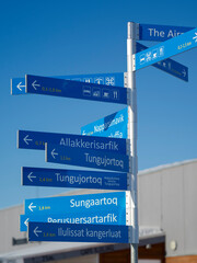 Signpost. Winter in Ilulissat on the shore of Disko Bay. Greenland, Denmark